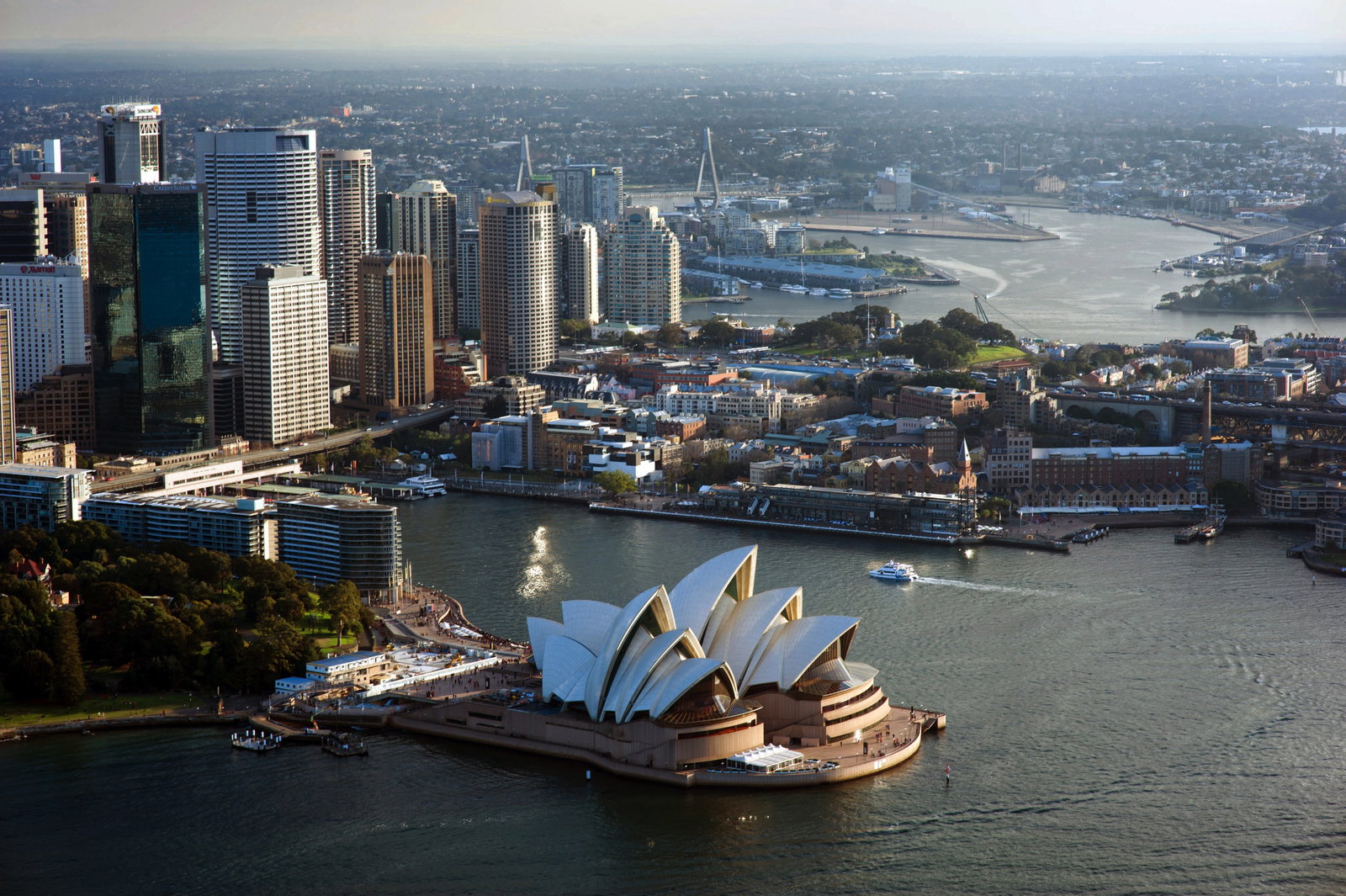 Sydney Opera House and Harbour Bridge with a cruise ship in the water.