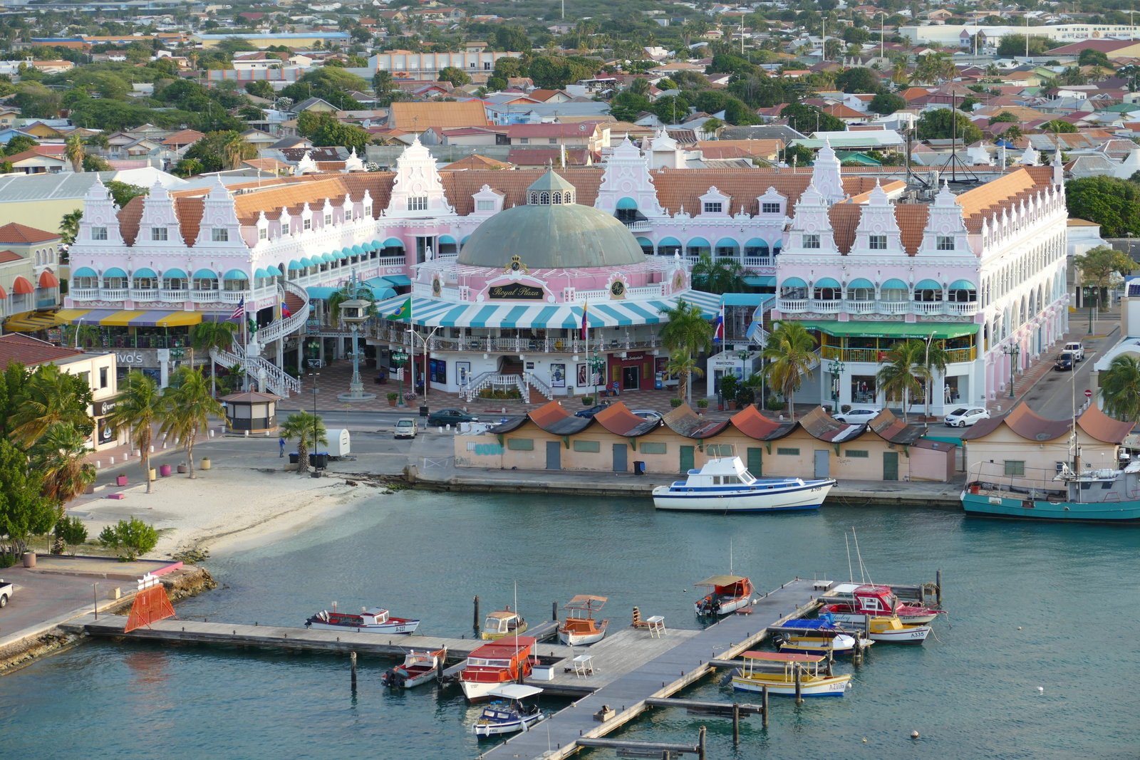 Colorful Dutch-style buildings line a bustling street in Oranjestad, Aruba.