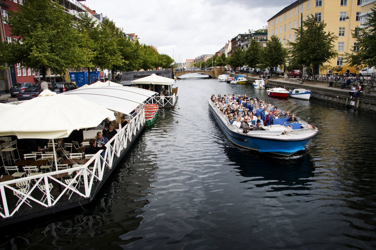 Colorful buildings line a canal with boats in Copenhagen, Denmark