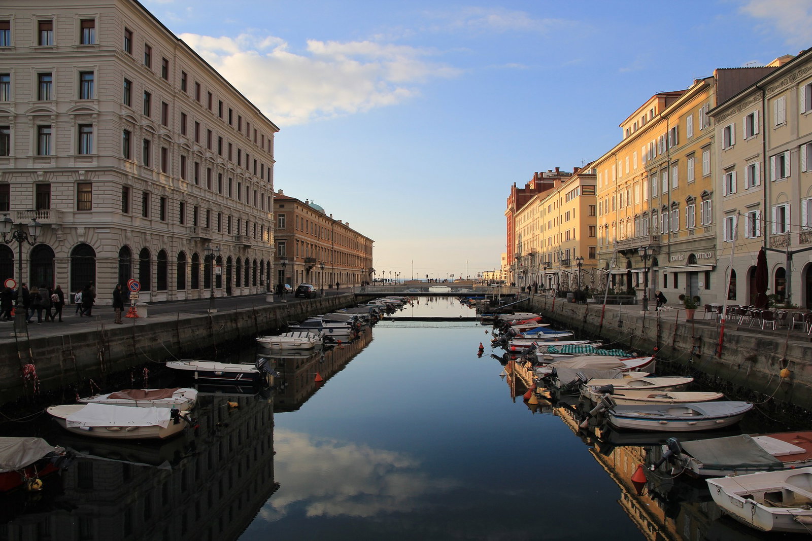 Historic waterfront buildings in Trieste, Italy, under a clear sky.
