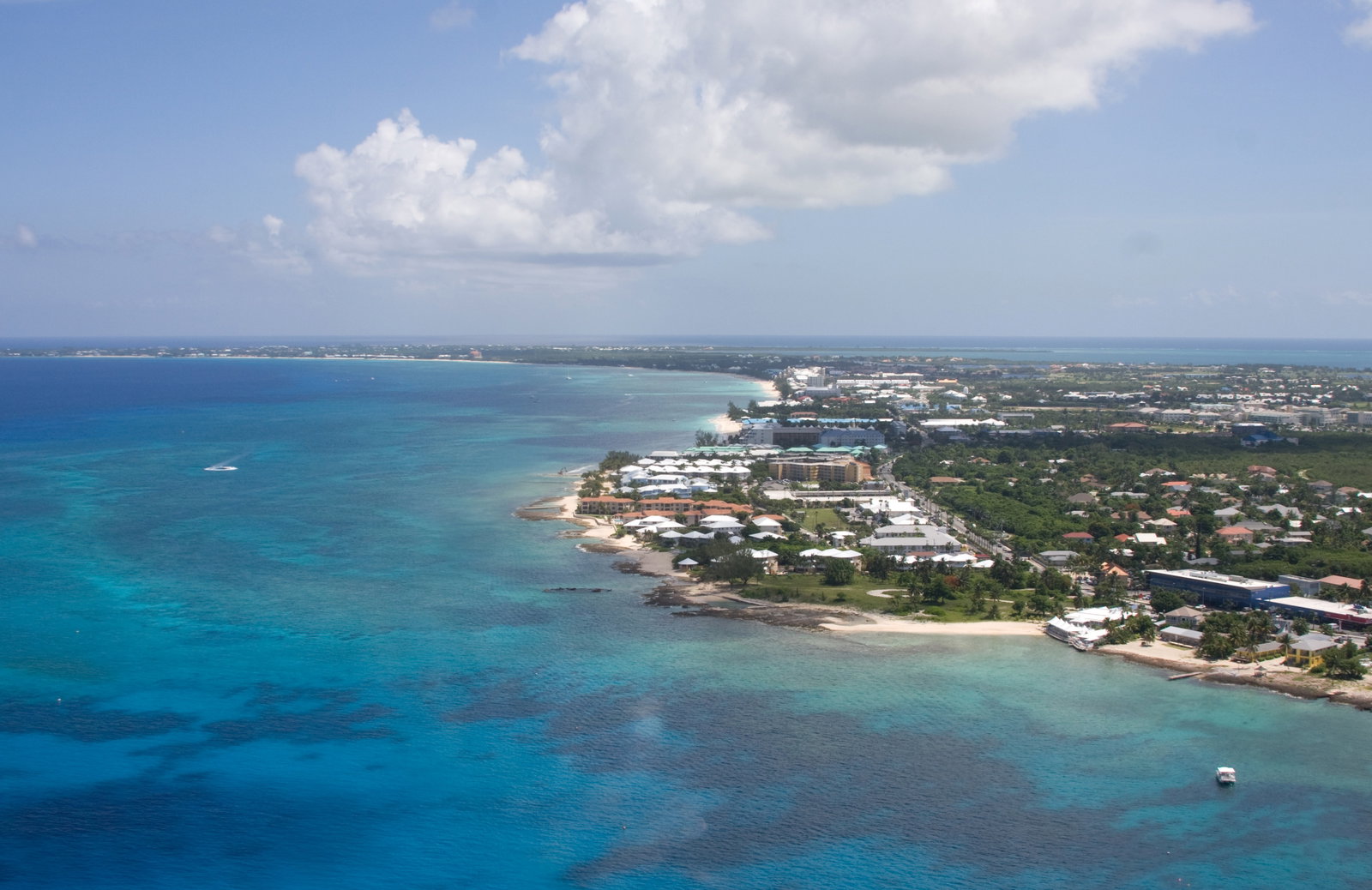 Colorful buildings and a bustling street scene in Georgetown, Grand Cayman