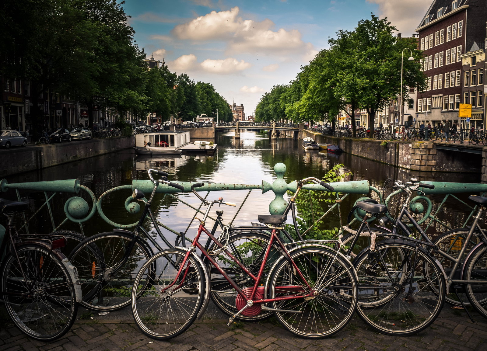 Amsterdam — NLAMS Amsterdam assorted-color bicycles park beside blue rails near river jace&afsoon.jpg