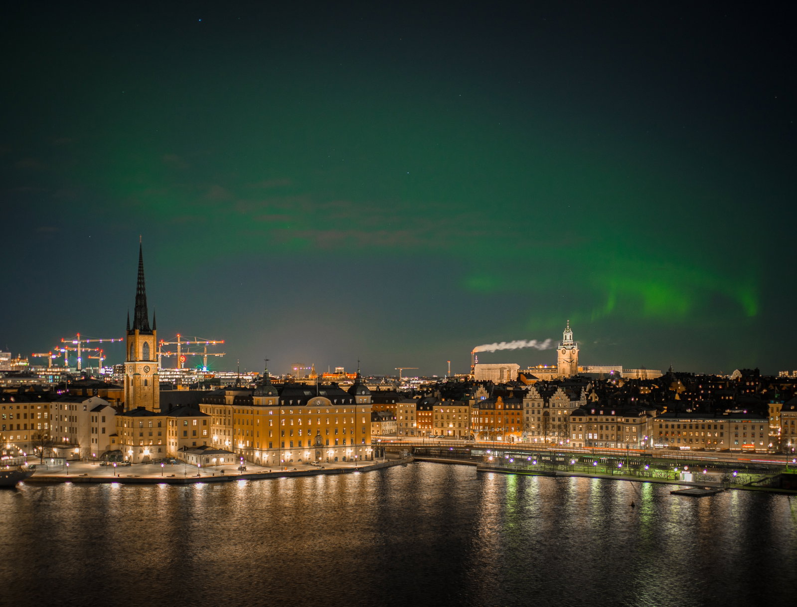 Historic buildings and modern architecture along Stockholm's waterfront at sunset