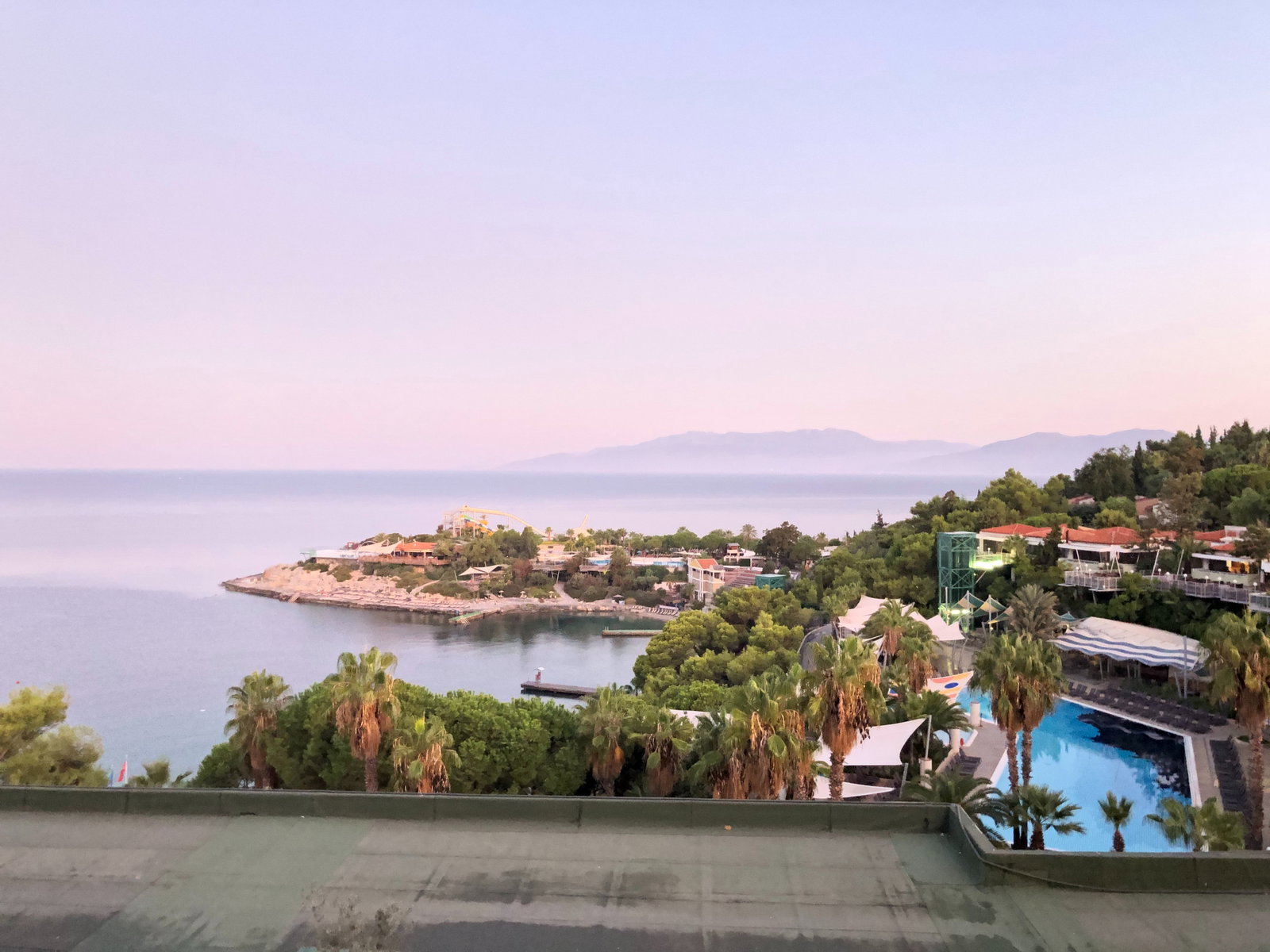 Panoramic view of Kusadasi port with a large cruise ship docked and town in background