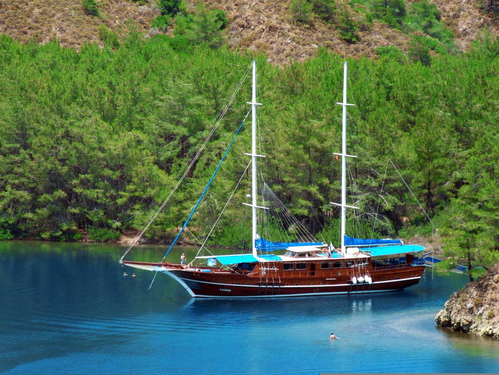 Cruise ship docked in Marmaris bay with pine-clad mountains in the background