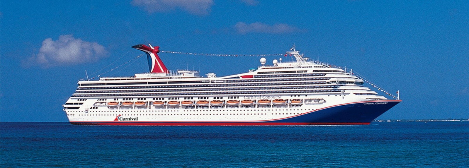 Carnival Conquest cruise ship sailing on blue ocean waters