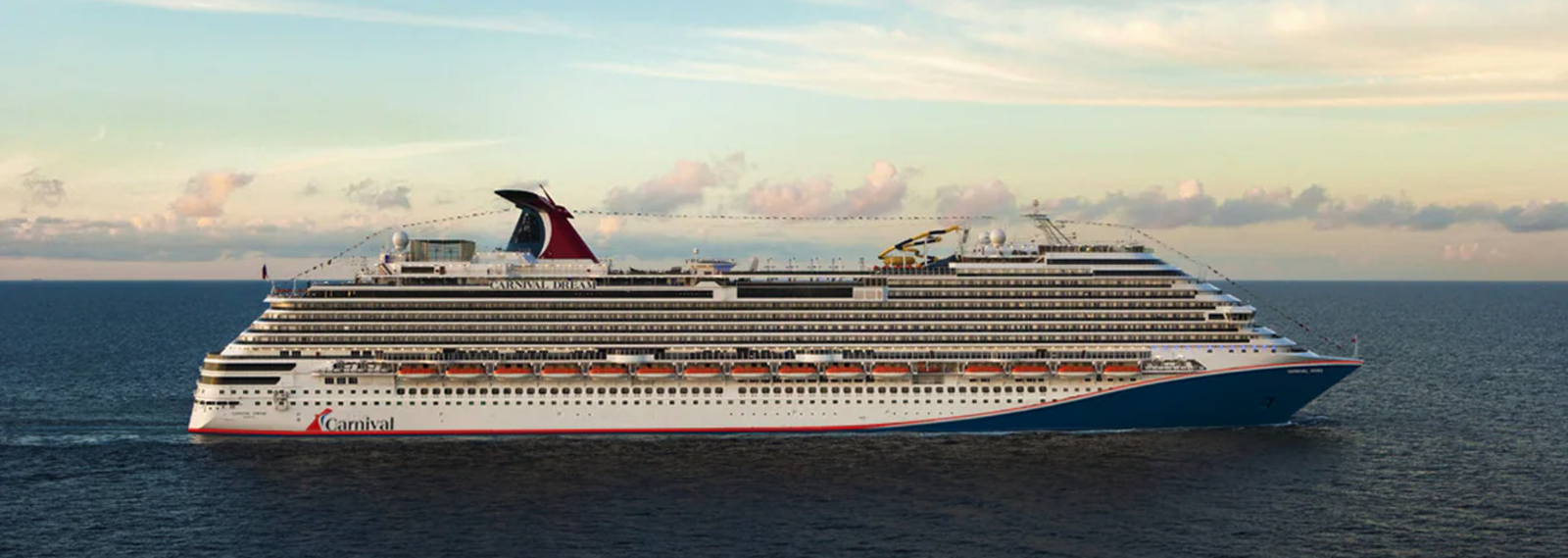 Cruise ship Carnival Dream sailing on blue waters under a clear sky.