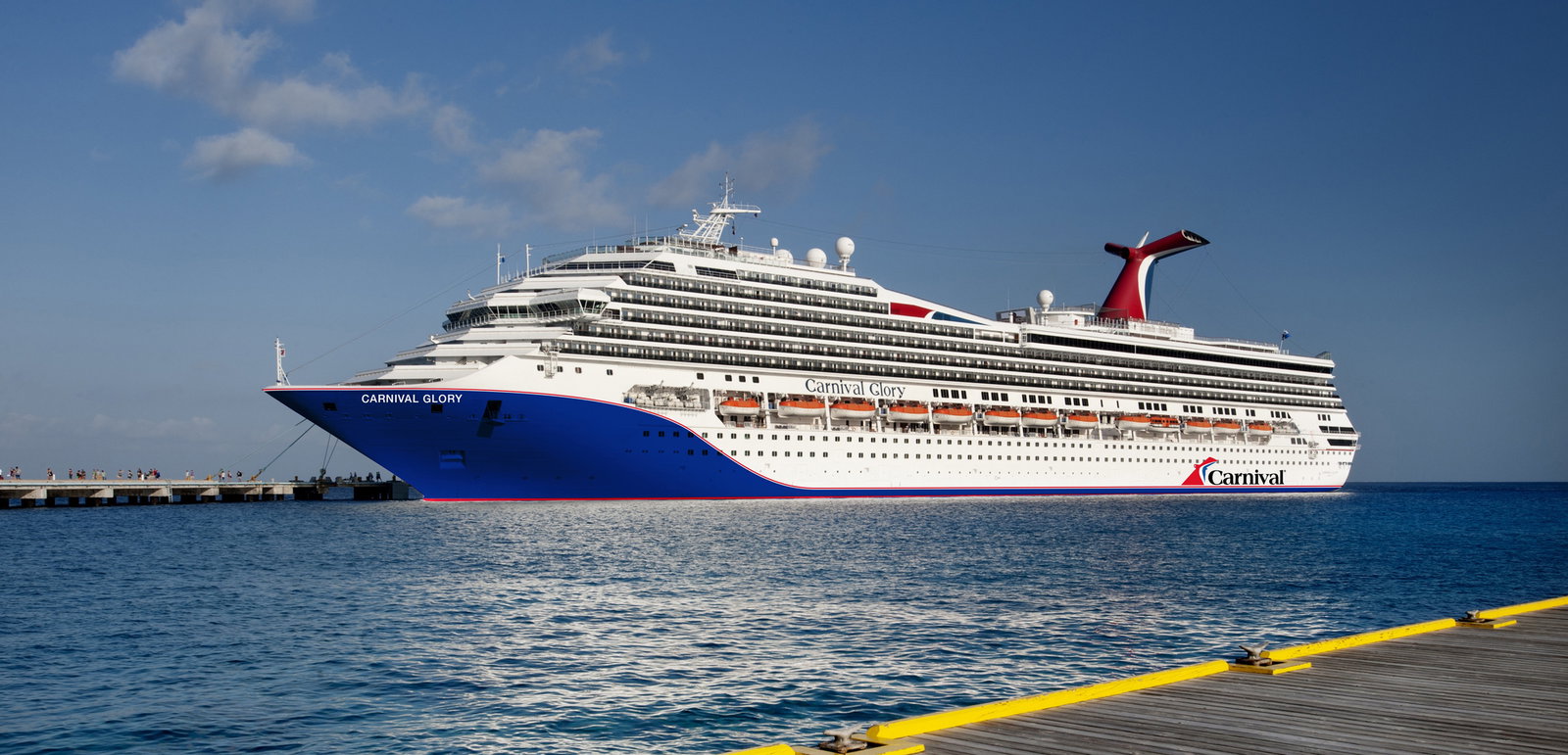 Aerial view of Carnival Glory sailing on blue ocean waters under a sunny sky.
