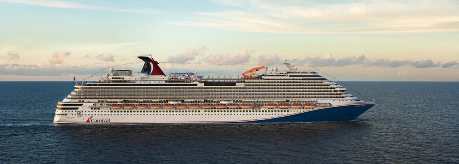 Aerial view of Carnival Magic cruise ship sailing on blue ocean waters.