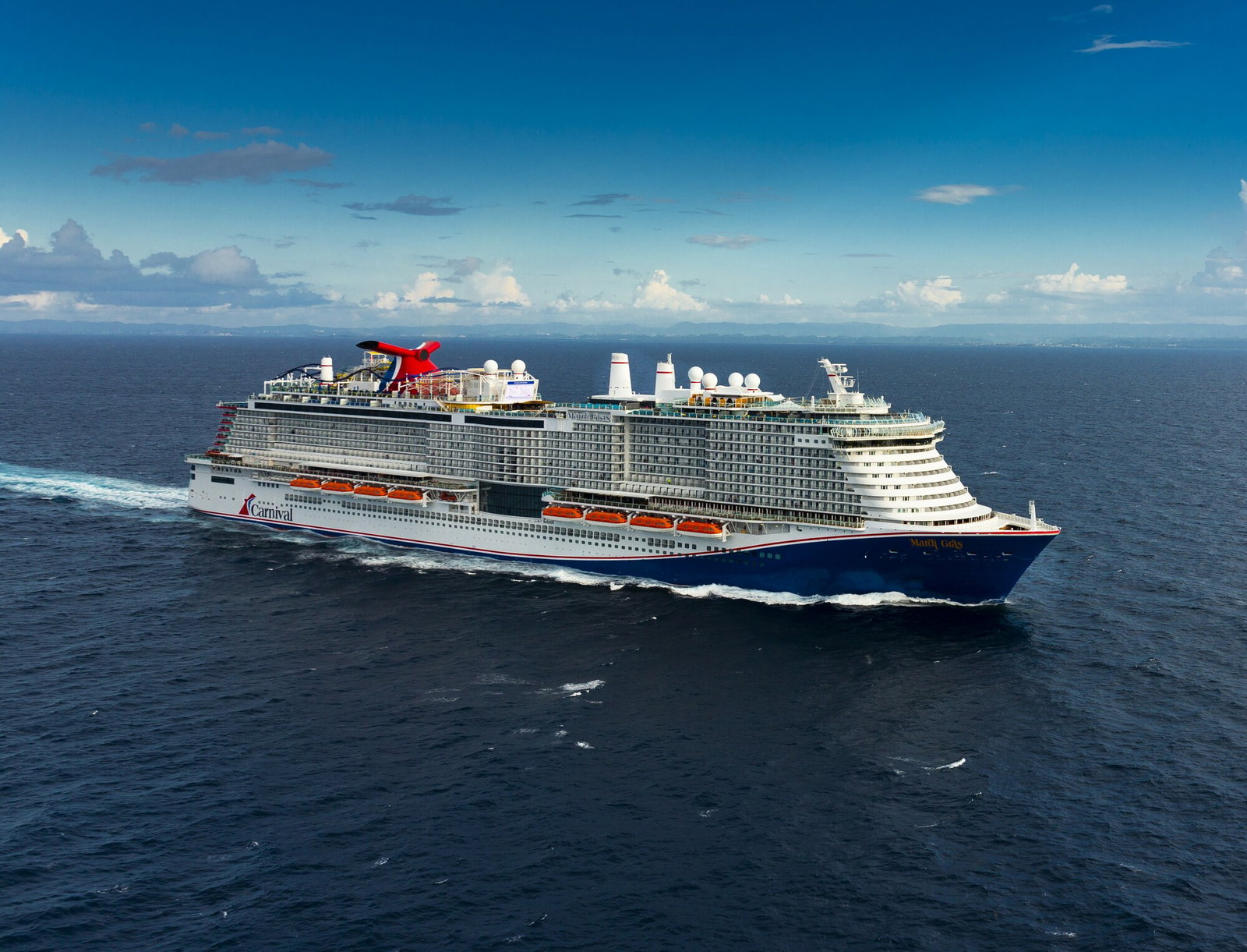 A vibrant cruise ship with a roller coaster track winding across its upper deck.