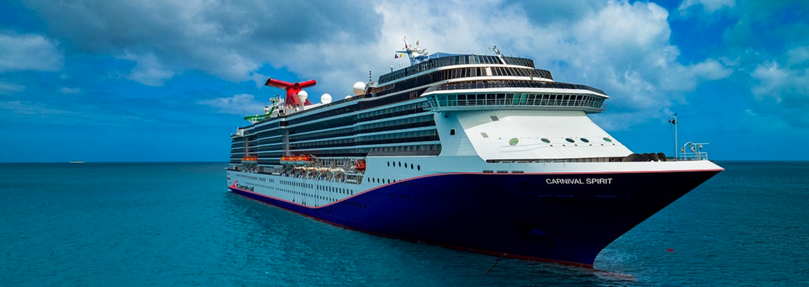 Families enjoying the Carnival WaterWorks slides on Carnival Spirit with ocean views.
