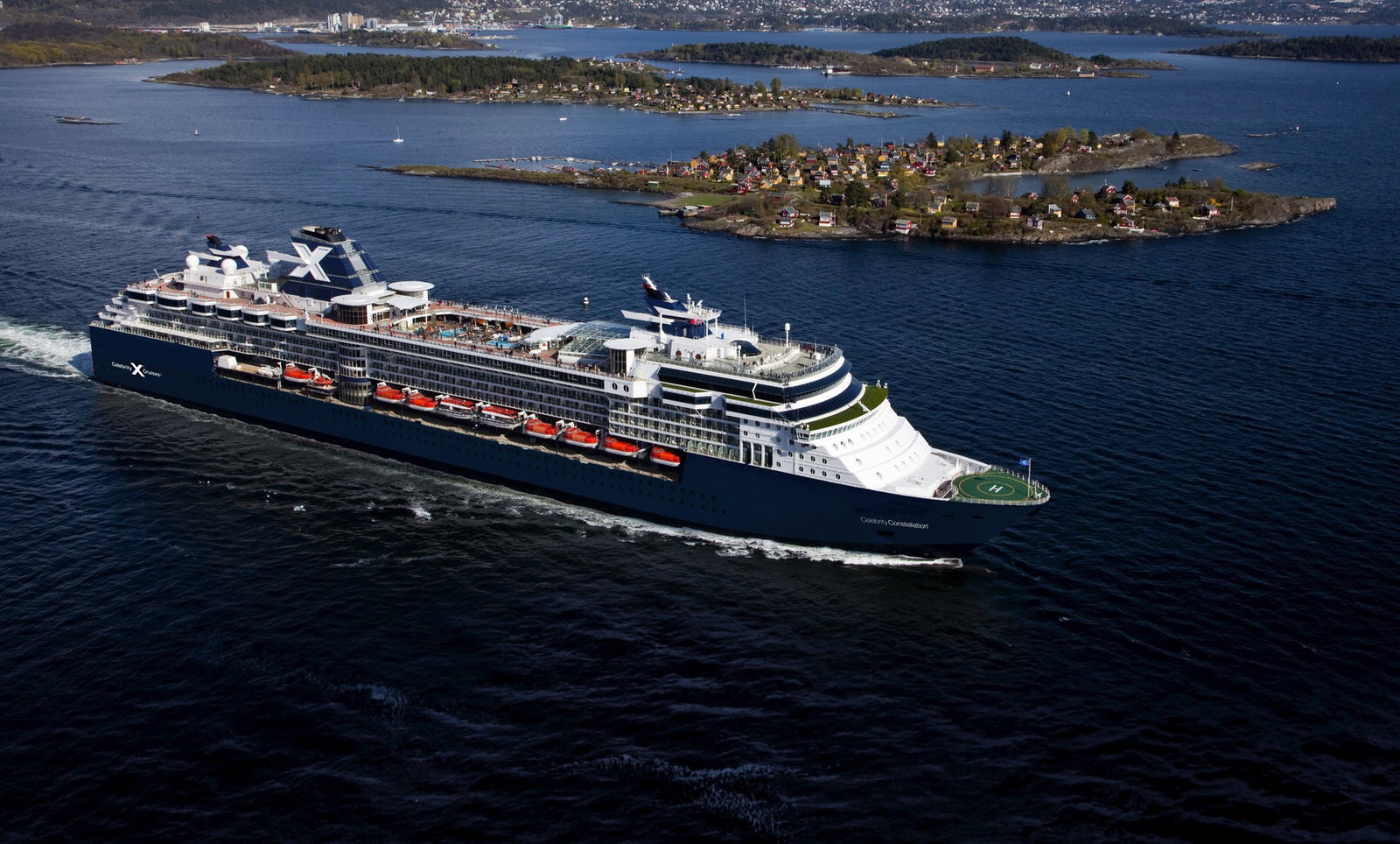 Celebrity Constellation cruise ship sailing on calm blue waters at sunset