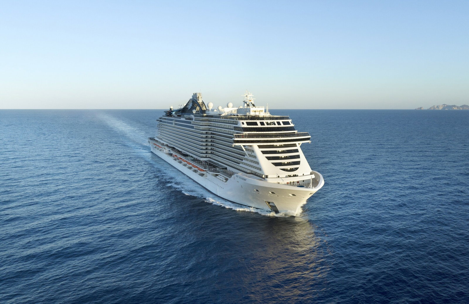 Exterior view of MSC Seashore cruise ship sailing on blue ocean waters.