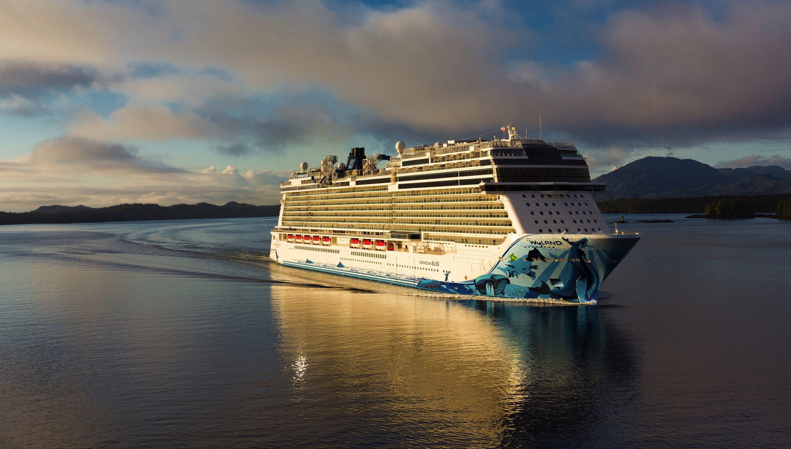 Aerial view of Norwegian Bliss sailing on calm blue waters under a clear sky.
