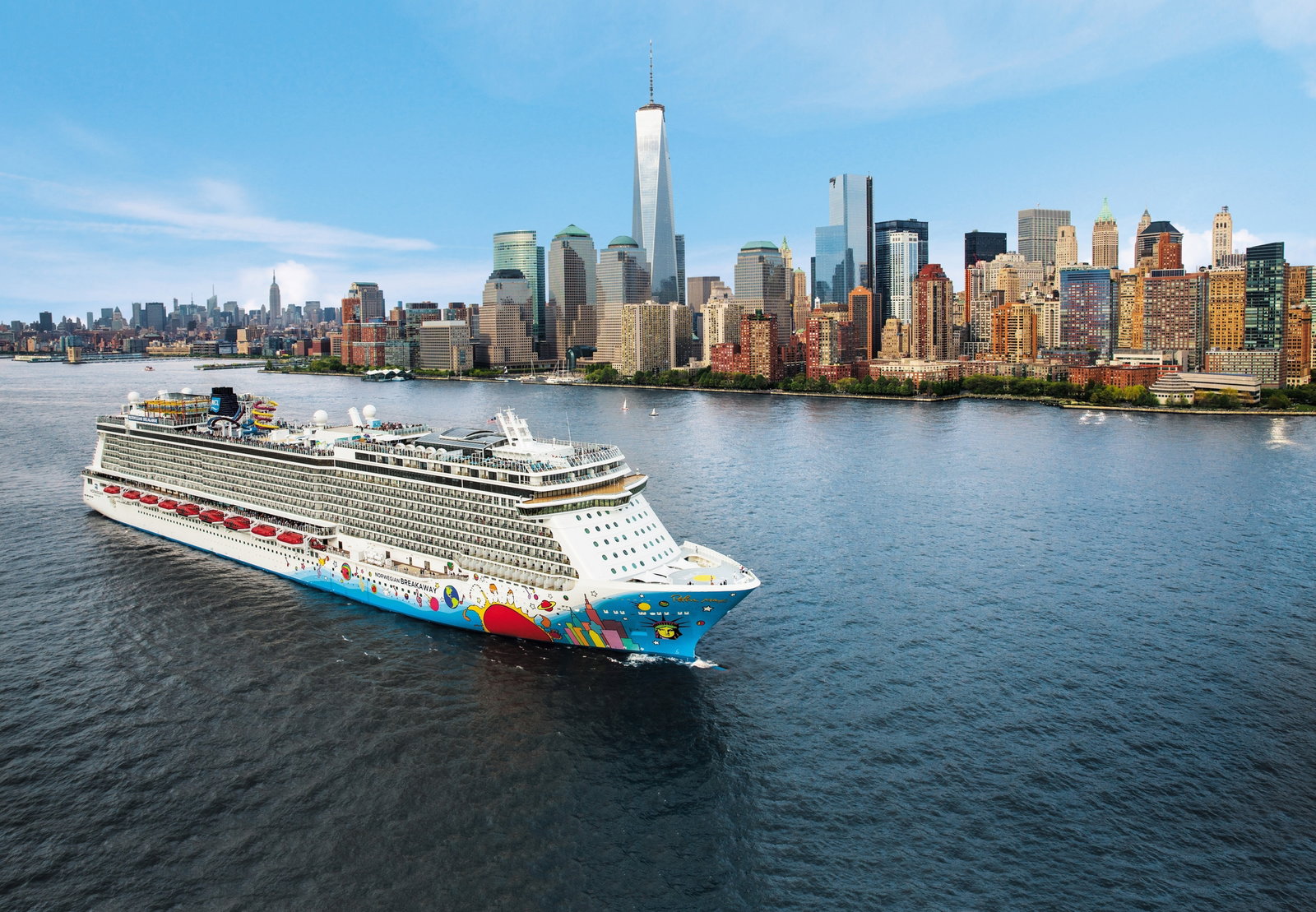 Norwegian Breakaway cruise ship sailing on a sunny day with passengers enjoying the decks.