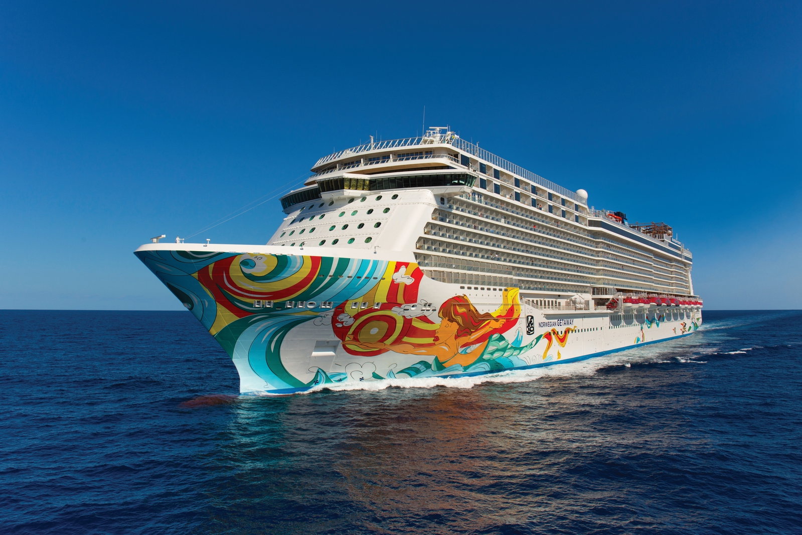 Norwegian Getaway cruise ship sailing on clear blue waters under a sunny sky