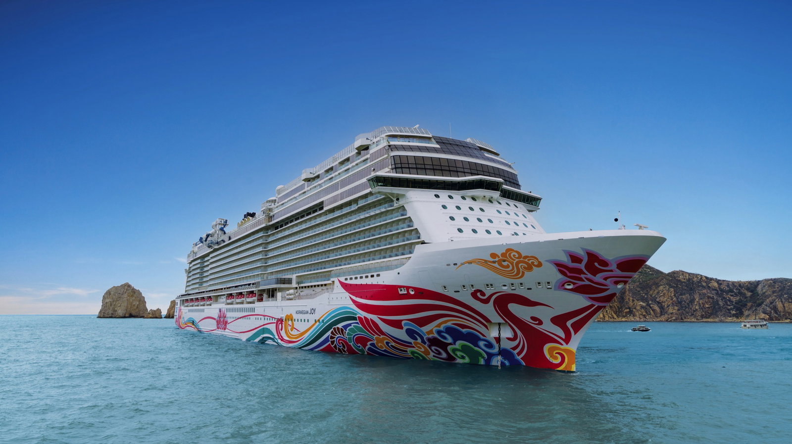 Aerial view of Norwegian Joy cruising on the ocean under a clear sky