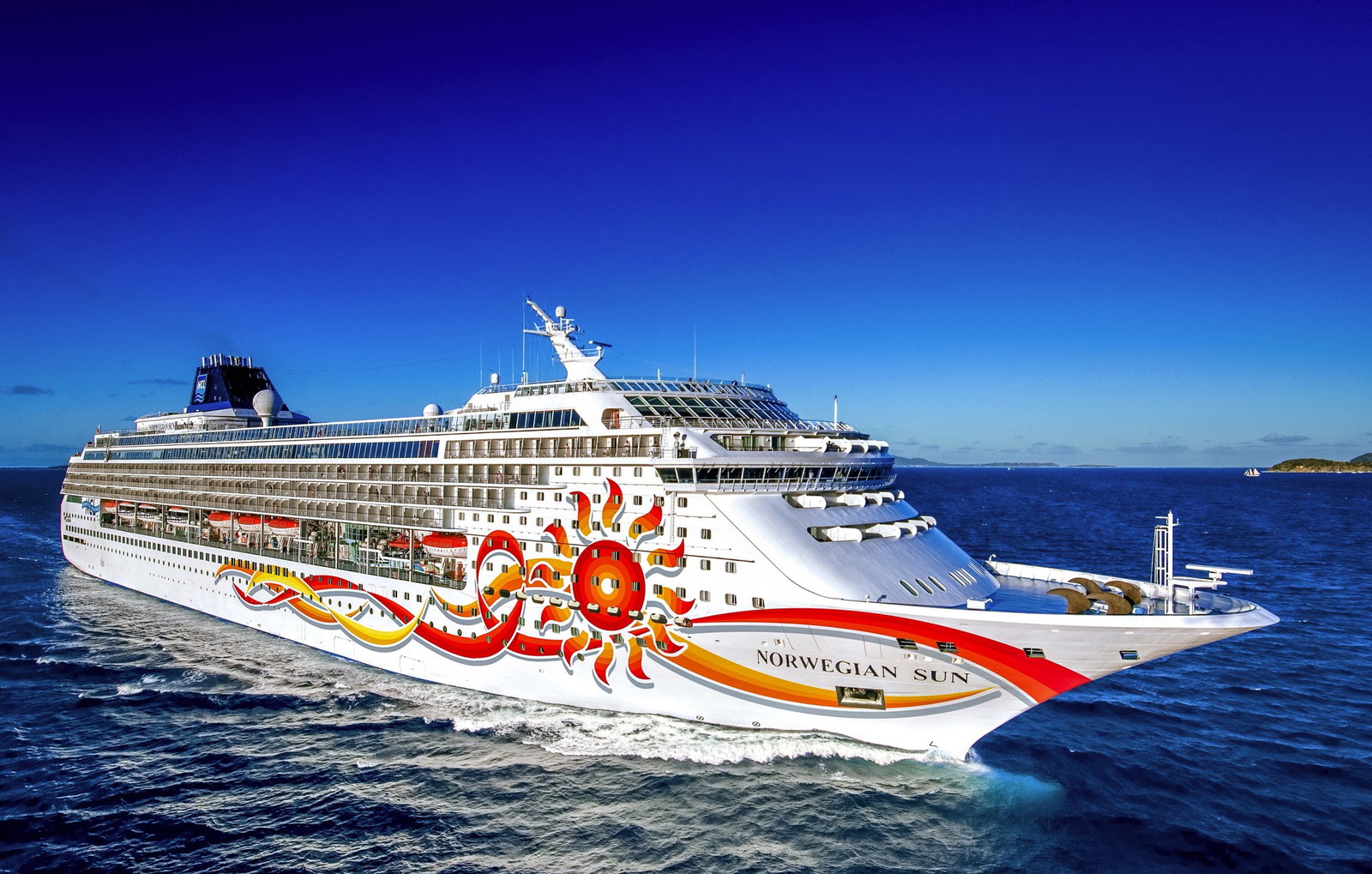 Cruise ship Norwegian Sun sailing on calm blue waters under a clear sky.