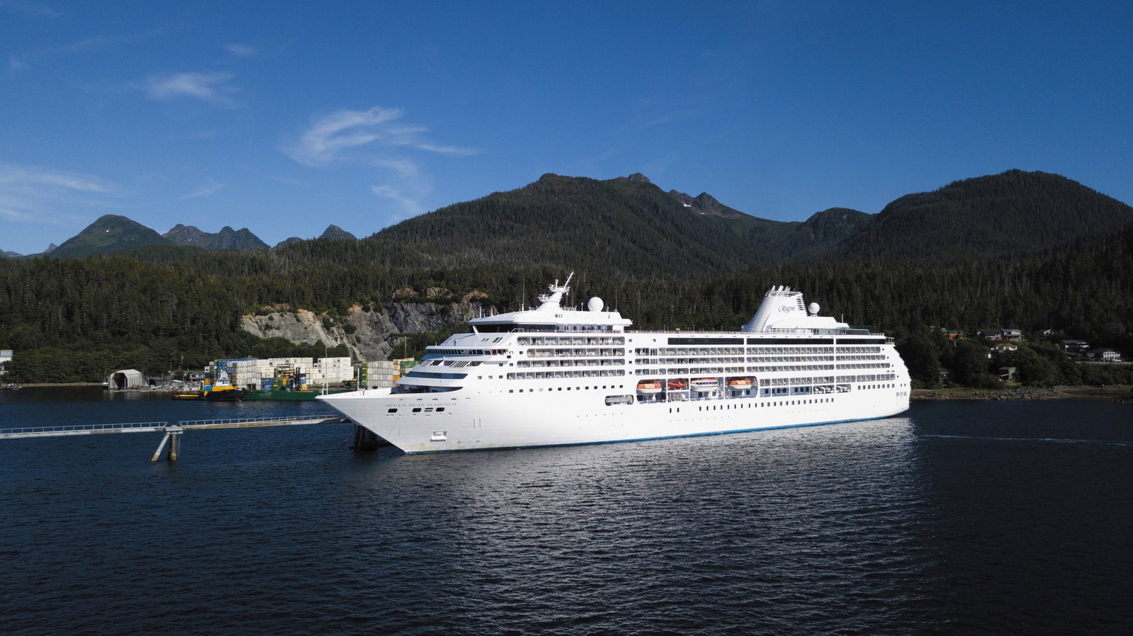 Luxury cruise ship Seven Seas Mariner sailing on calm blue waters at sunset