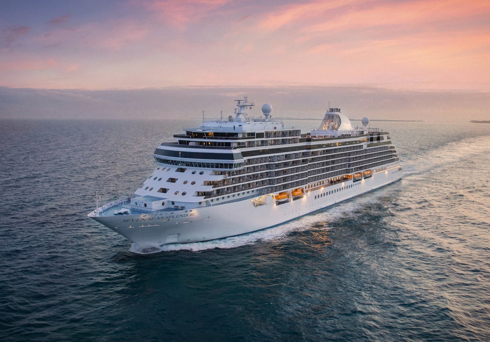 Luxury cruise ship Seven Seas Splendor sailing on calm, blue waters.