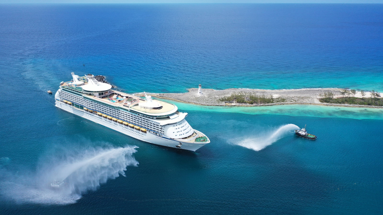 Families enjoying waterslides and a surf simulator on a cruise ship deck.