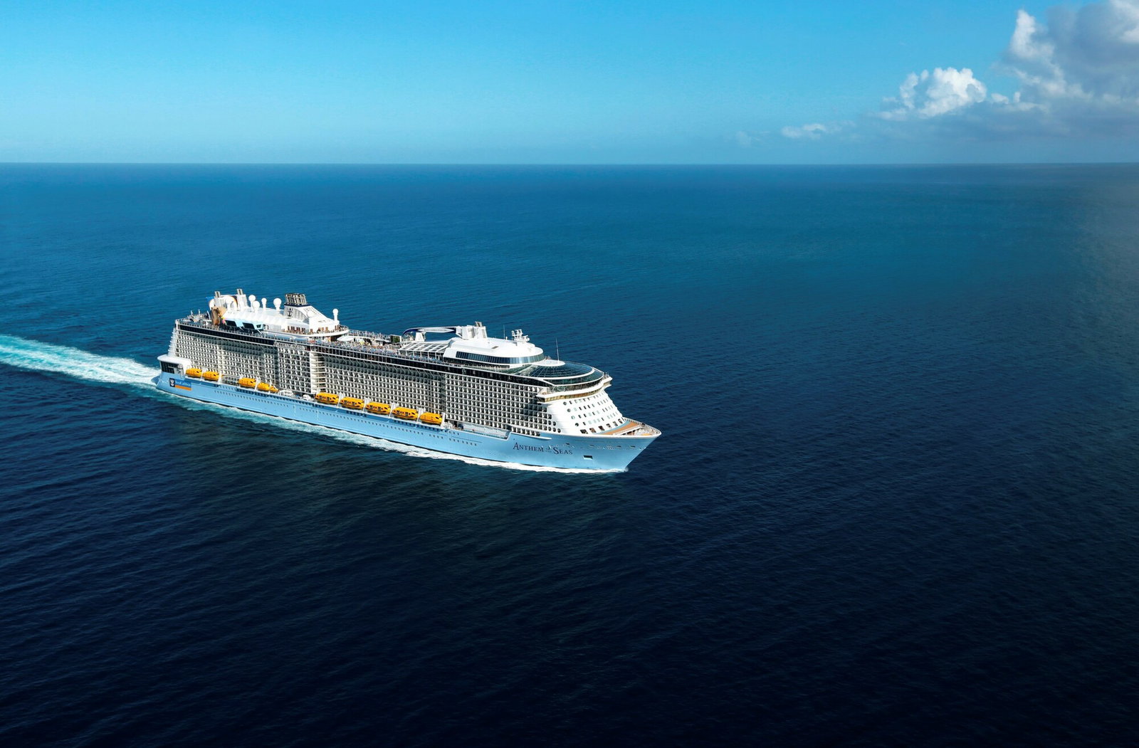 Anthem of the Seas cruise ship sailing through blue waters at sunset