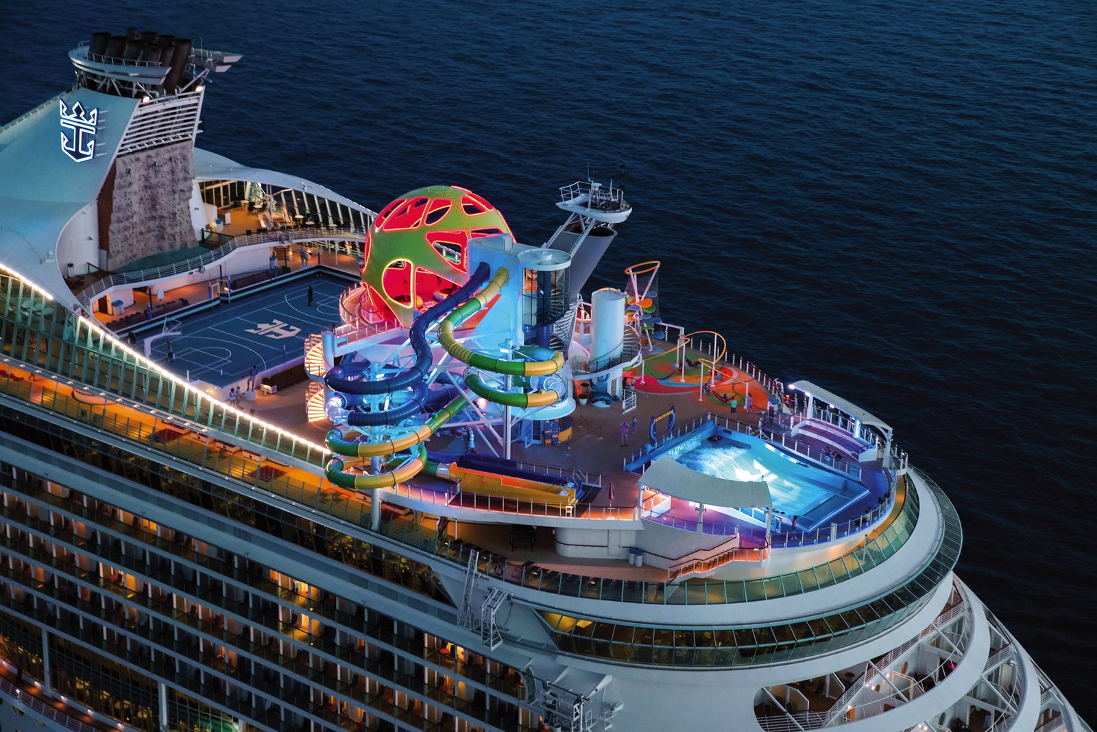 Families enjoying the FlowRider surf simulator on Mariner of the Seas cruise ship.