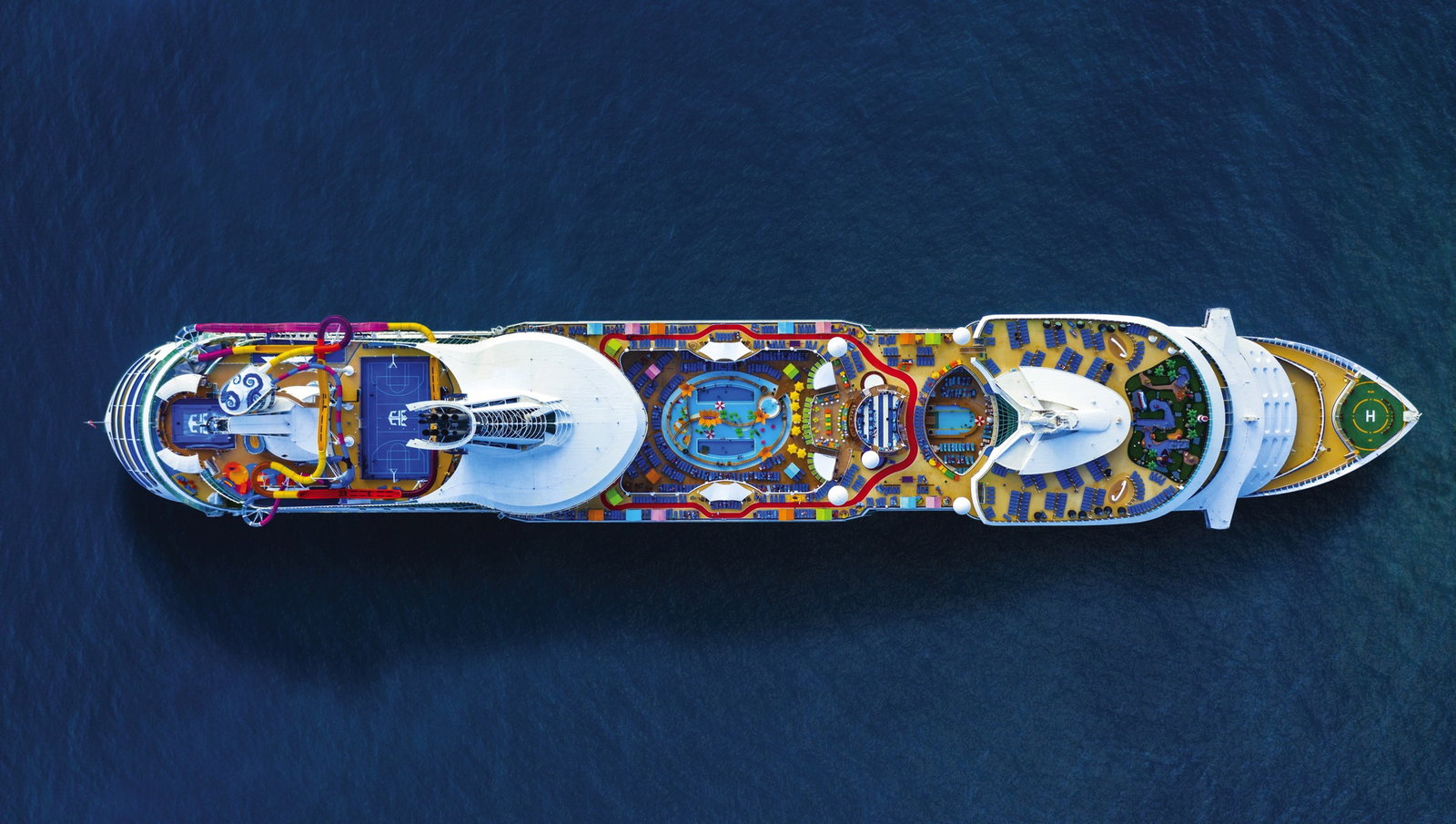 Families enjoying waterslides and a lively pool deck on Navigator of the Seas at sea.