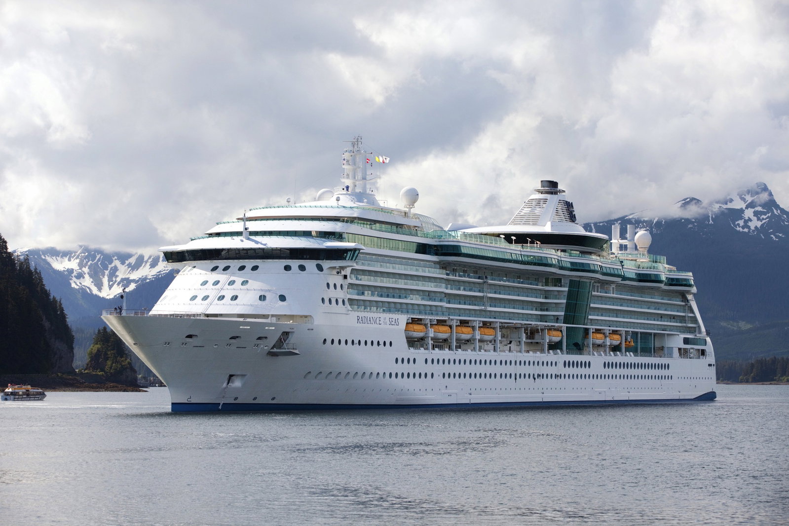 Radiance of the Seas cruise ship sailing on calm blue ocean waters under a clear sky.